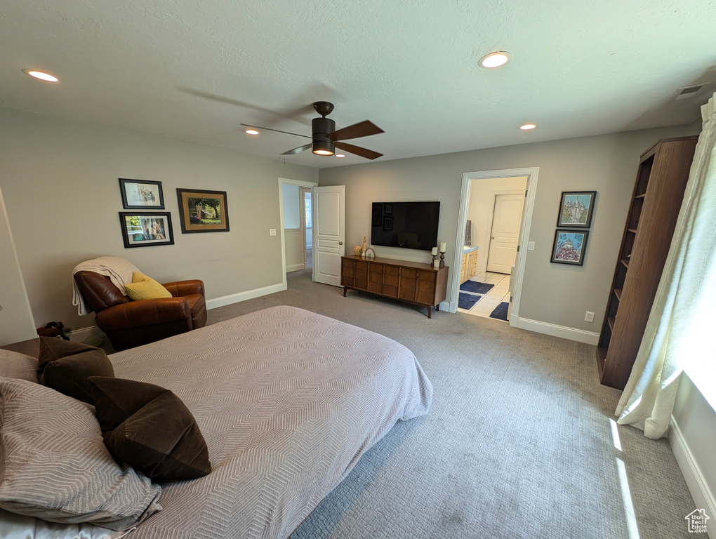 Carpeted bedroom featuring ceiling fan