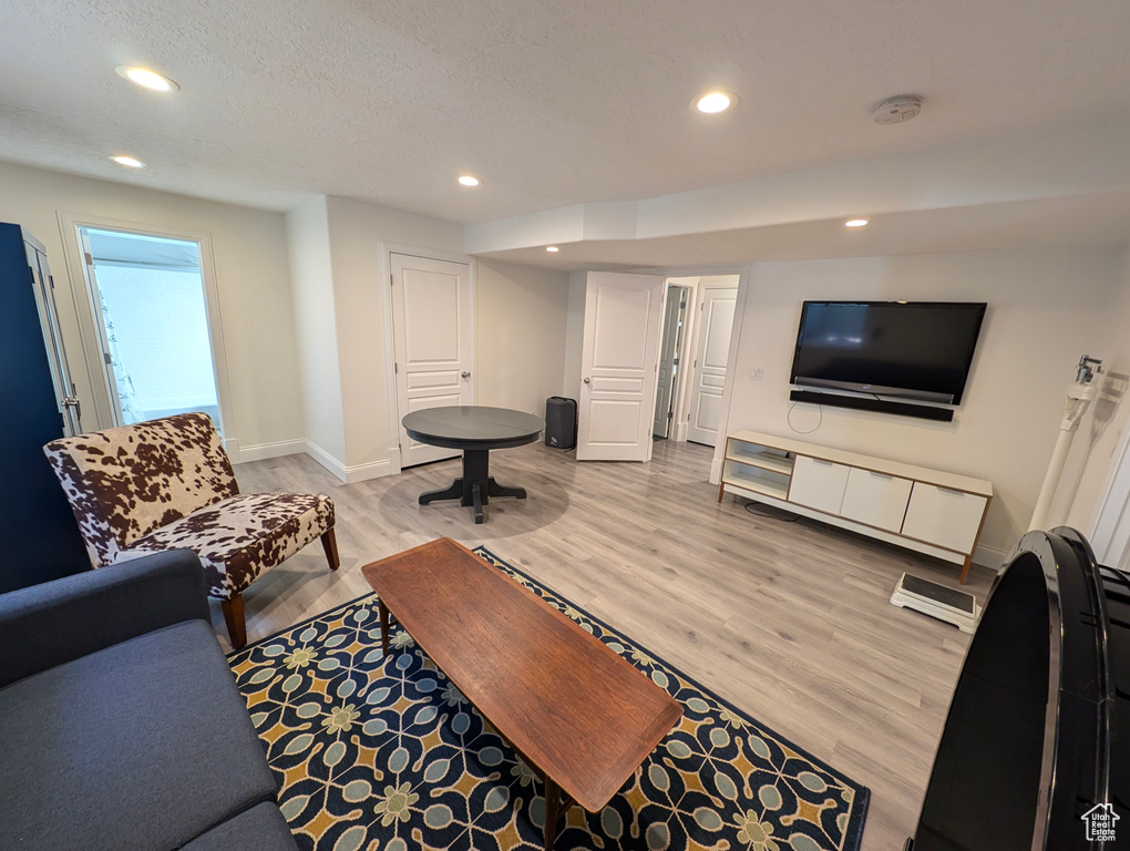 Living room with hardwood / wood-style floors and a textured ceiling