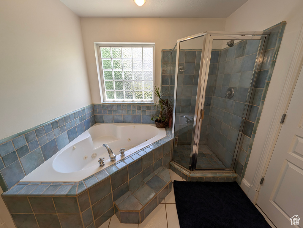 Bathroom featuring independent shower and bath and tile patterned floors