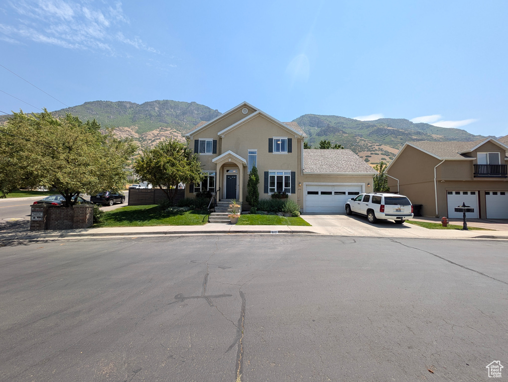 Front facade with a garage and a mountain view