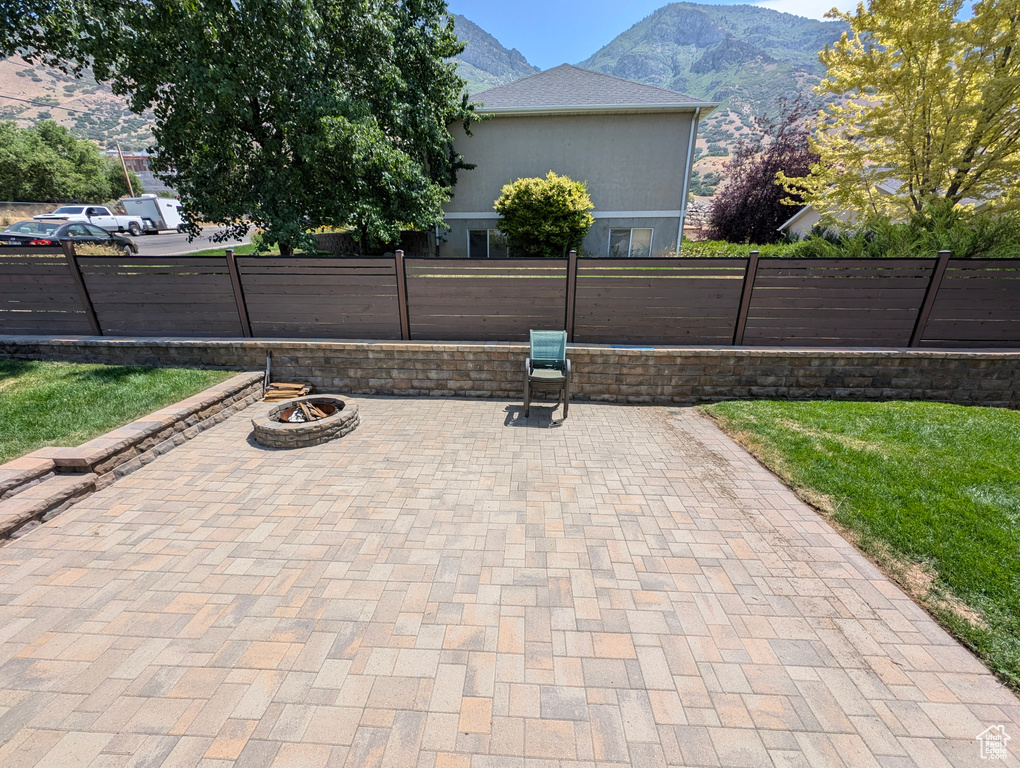 View of patio / terrace featuring a mountain view and an outdoor fire pit