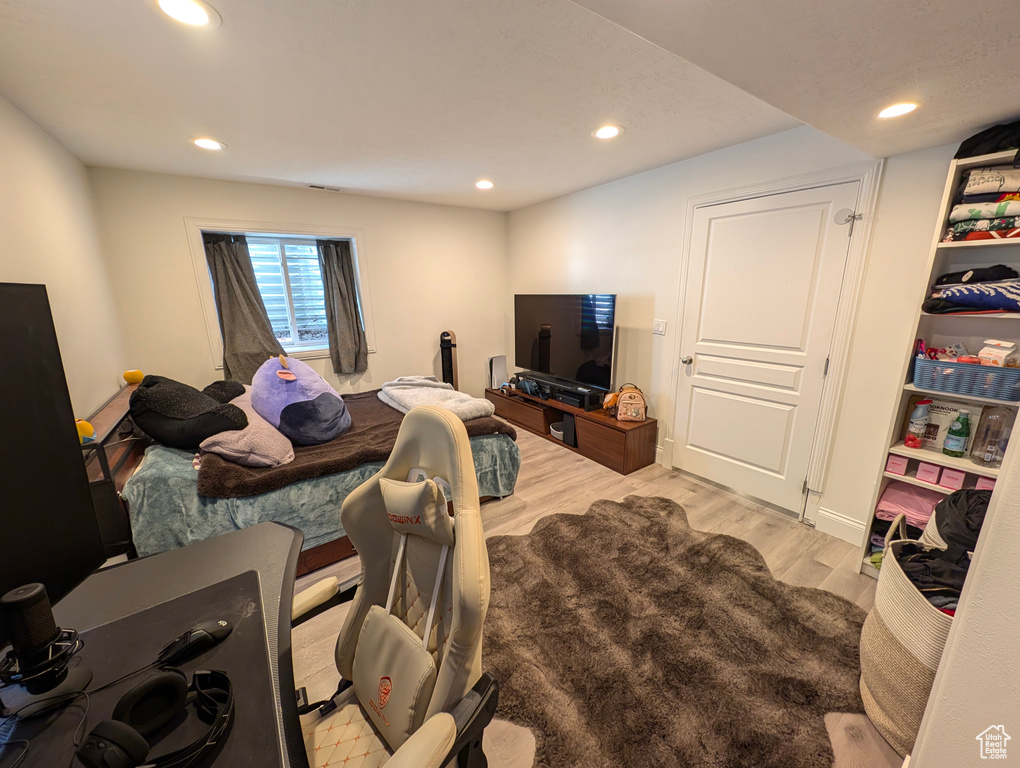 Bedroom with hardwood / wood-style floors