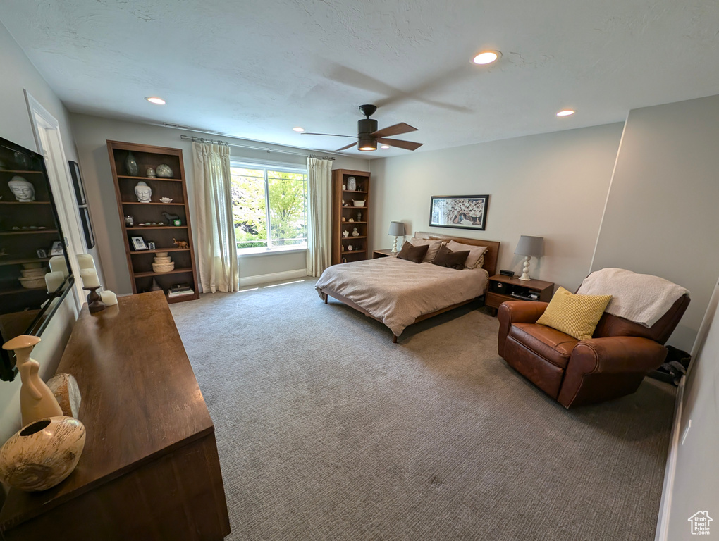 Carpeted bedroom with ceiling fan