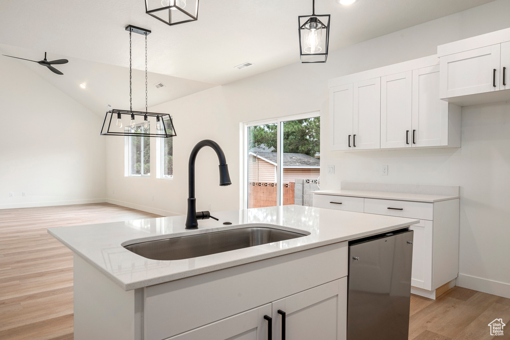 Kitchen with dishwasher, decorative light fixtures, a kitchen island with sink, and light wood-type flooring