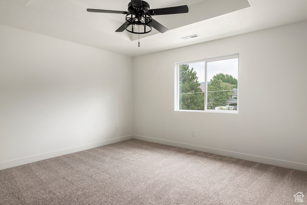 Unfurnished room featuring carpet floors and ceiling fan