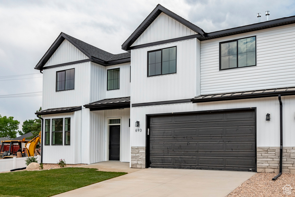 Modern farmhouse featuring a garage