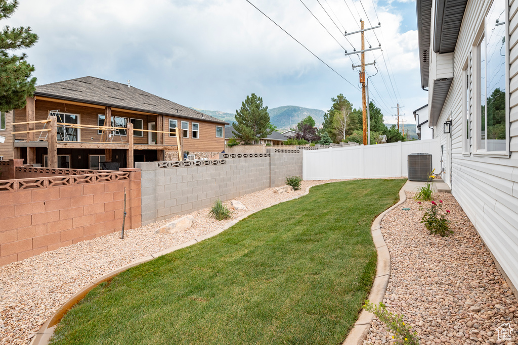 View of yard featuring central AC and a mountain view