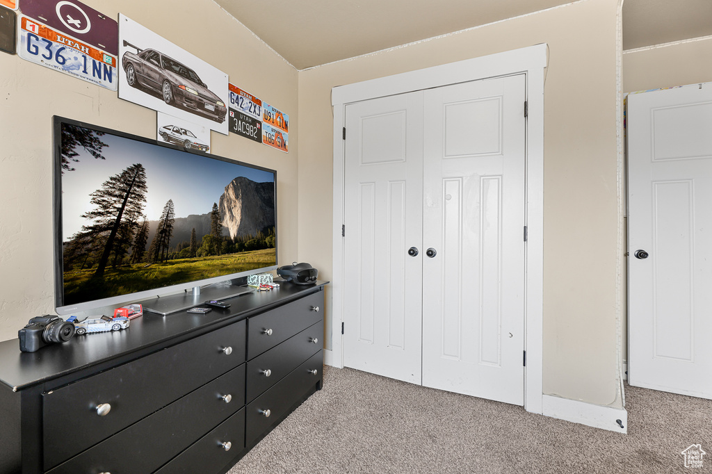 Carpeted bedroom with a closet