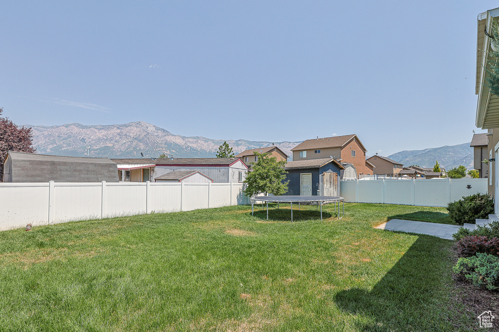 View of yard with a mountain view and a trampoline