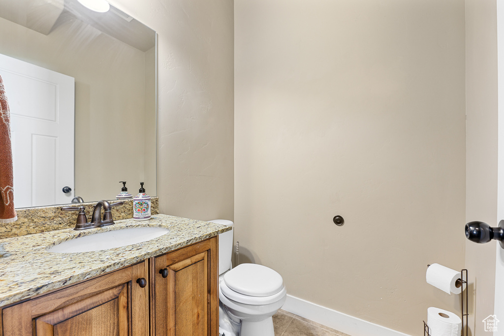 Bathroom with vanity, tile patterned flooring, and toilet