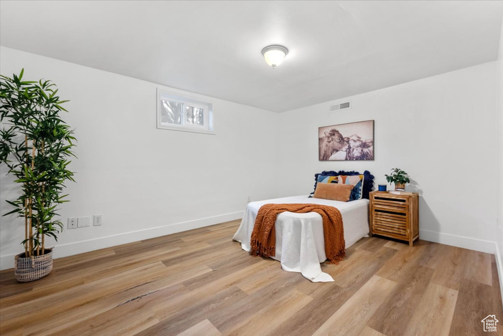 Bedroom with wood-type flooring