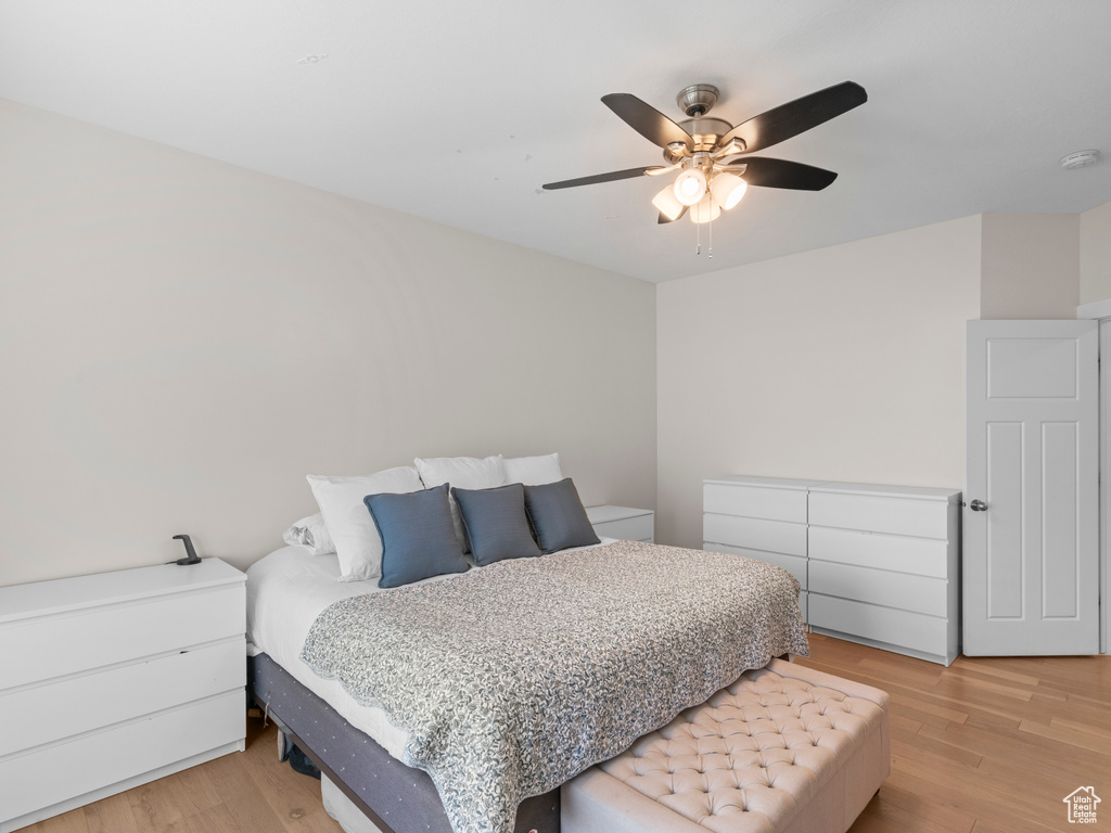 Bedroom with ceiling fan and light hardwood / wood-style floors