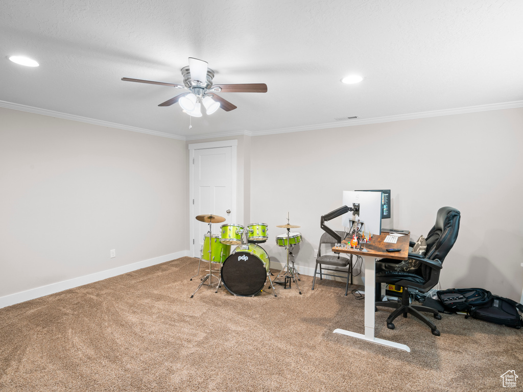 Office area with carpet flooring, ornamental molding, and ceiling fan