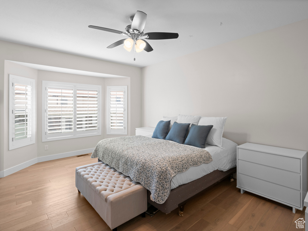 Bedroom with ceiling fan and light hardwood / wood-style floors