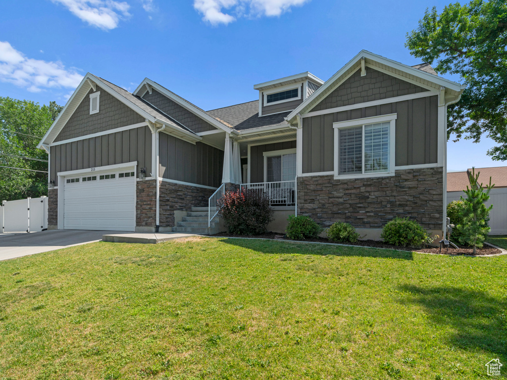 Craftsman-style home with a garage and a front yard