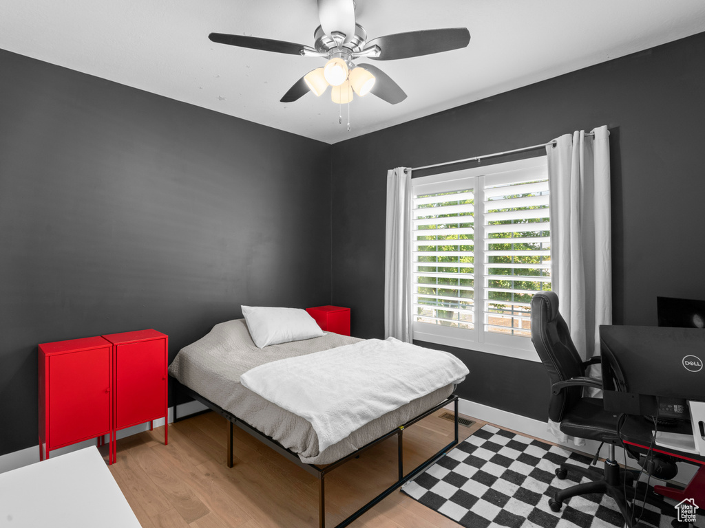 Bedroom featuring ceiling fan and hardwood / wood-style flooring