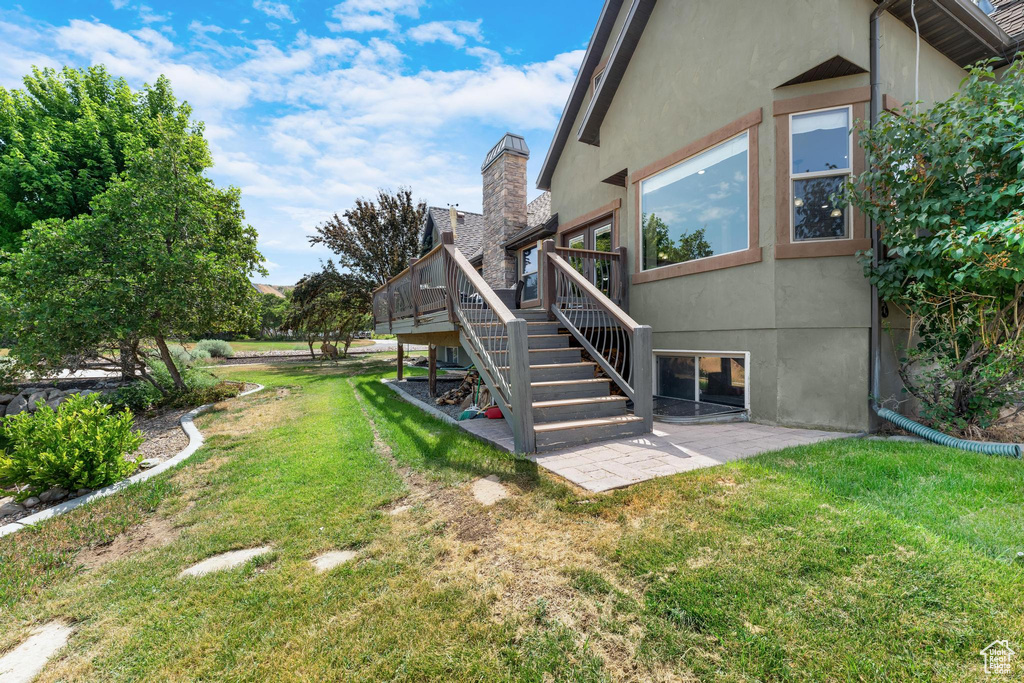 View of yard featuring a patio area and a wooden deck