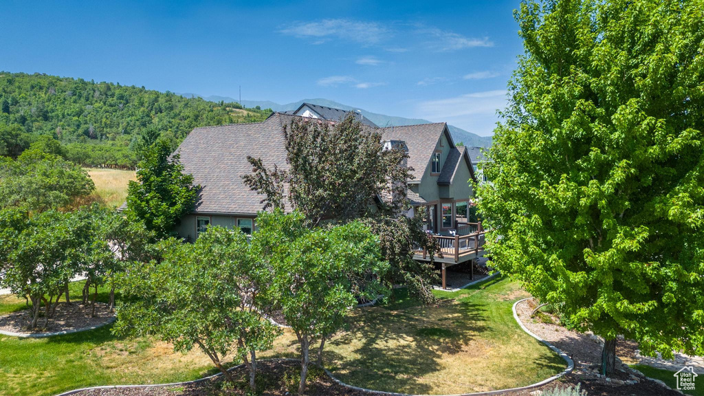 View of side of property featuring a yard and a deck