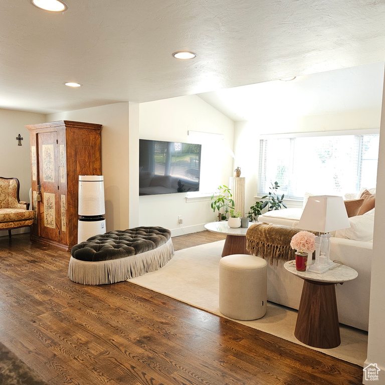 Living room with vaulted ceiling and hardwood / wood-style floors