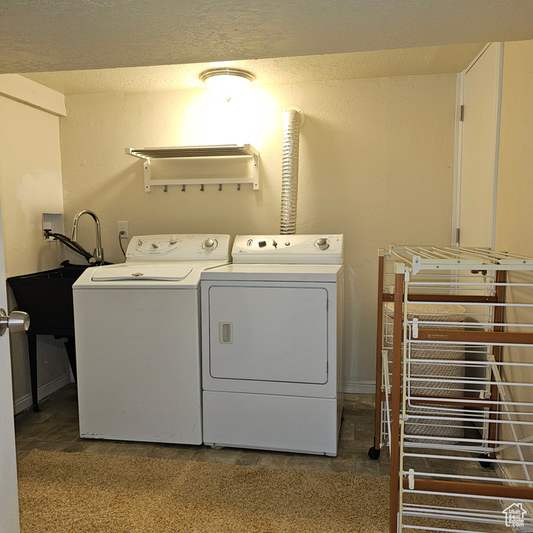 Laundry room with tile patterned flooring and washing machine and clothes dryer