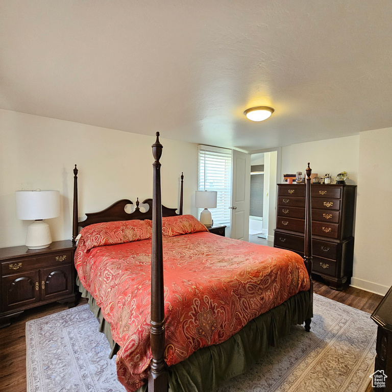 Bedroom with dark wood-type flooring