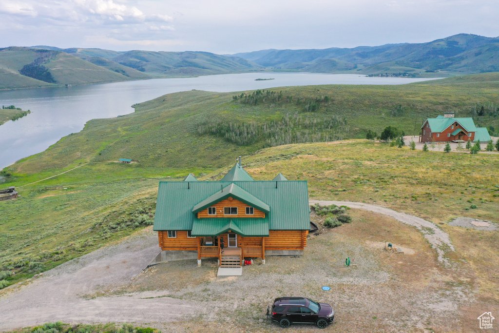 Drone / aerial view featuring a water and mountain view