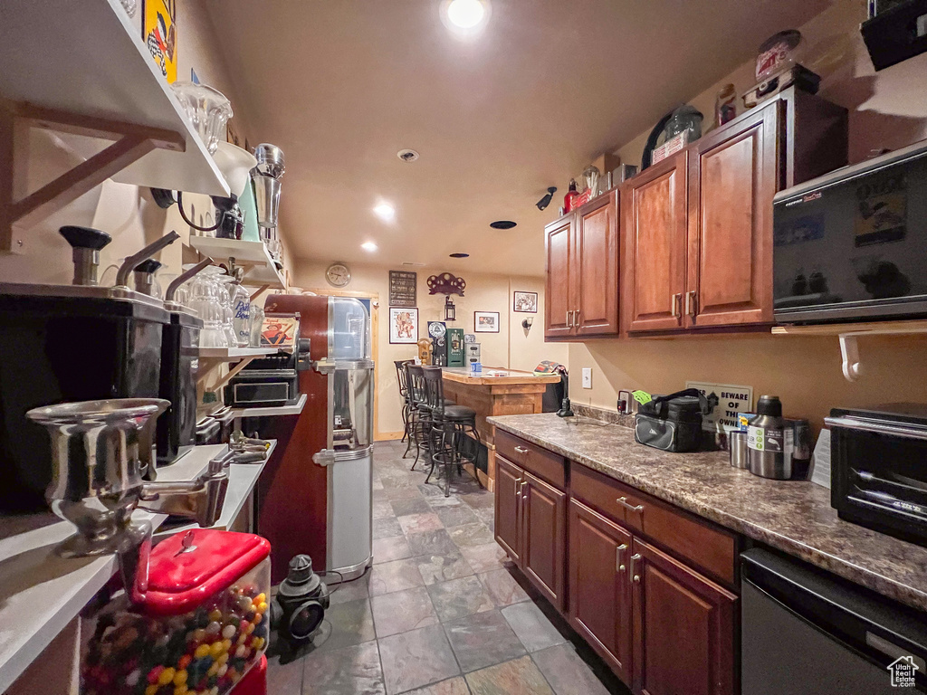 Kitchen with dishwasher and tile patterned flooring