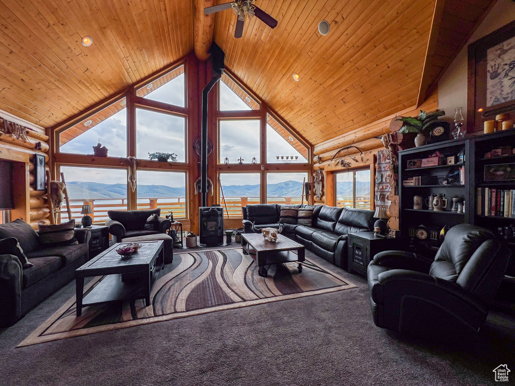 Living room featuring carpet, wooden ceiling, and high vaulted ceiling