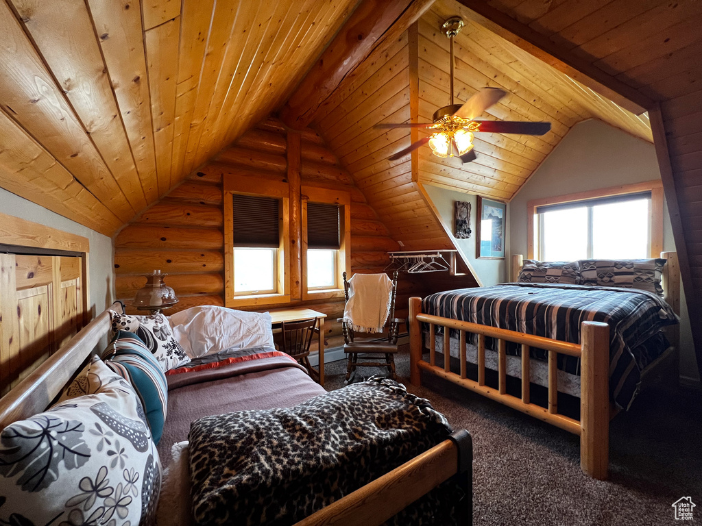 Carpeted bedroom with wood ceiling, ceiling fan, vaulted ceiling, and rustic walls