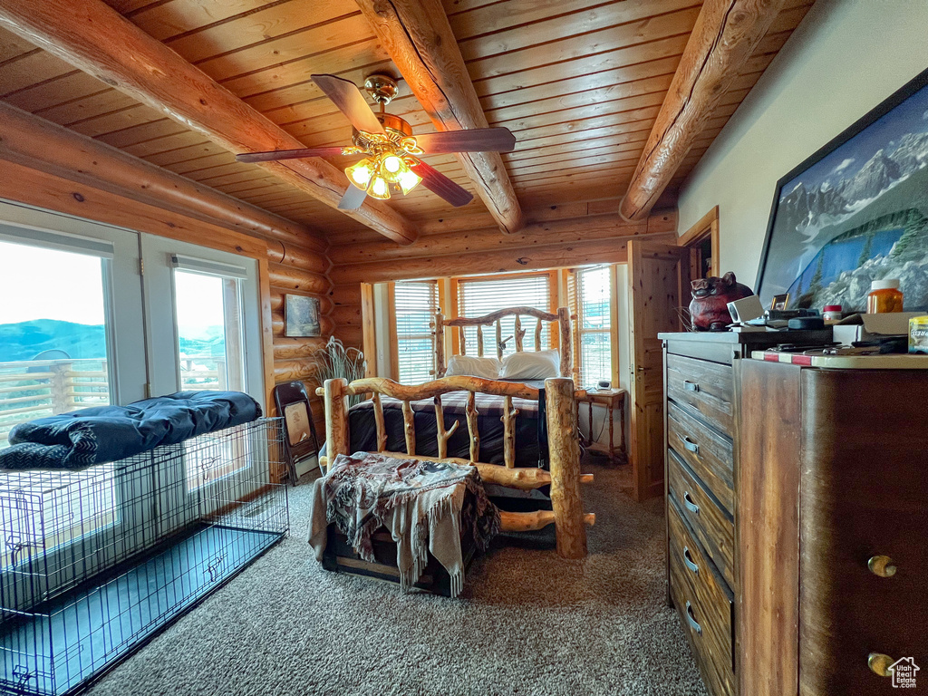 Bedroom with wood ceiling, multiple windows, and carpet