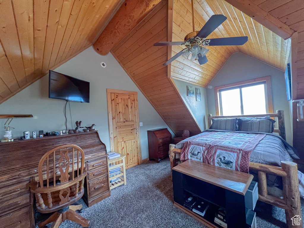 Bedroom with vaulted ceiling with beams, carpet floors, wooden ceiling, and ceiling fan