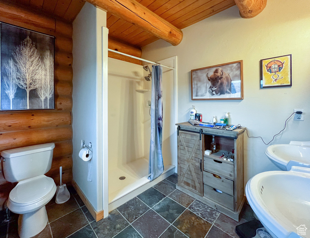 Bathroom featuring a shower with shower curtain, wooden ceiling, rustic walls, toilet, and tile patterned flooring