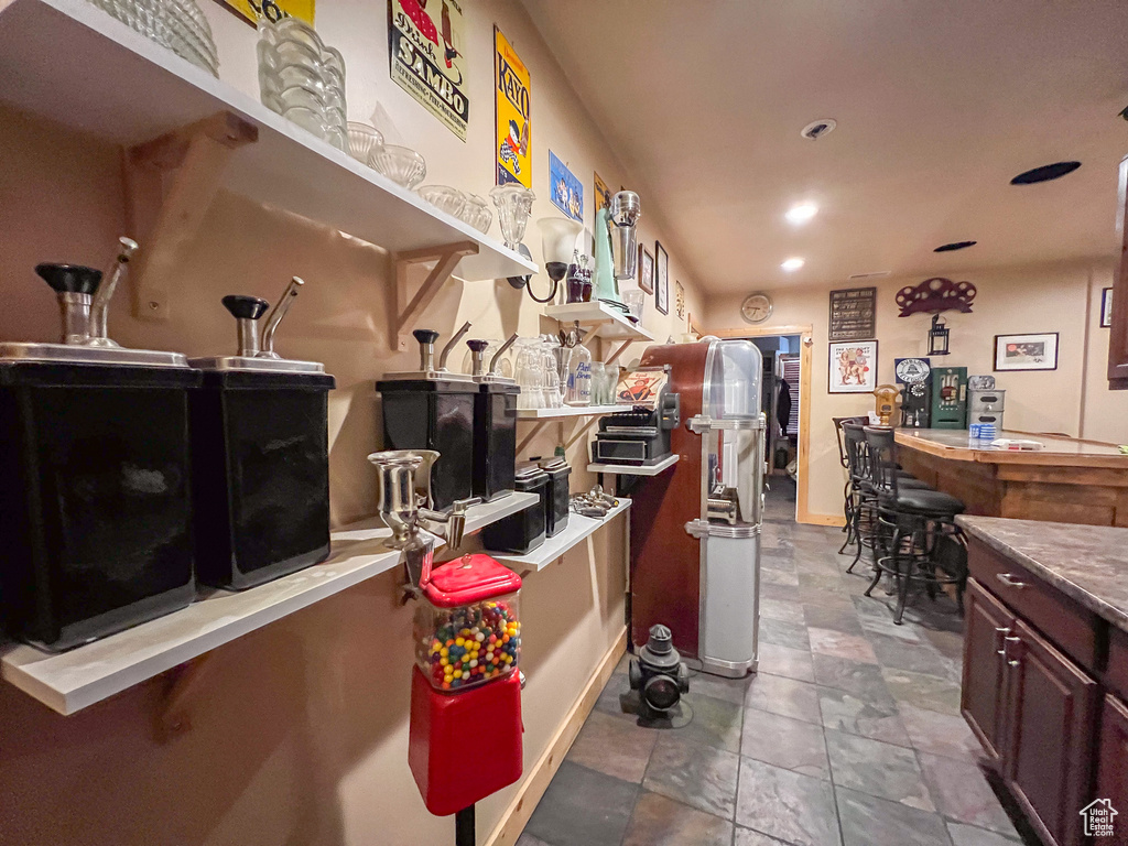 Kitchen with tile patterned flooring and dark brown cabinetry