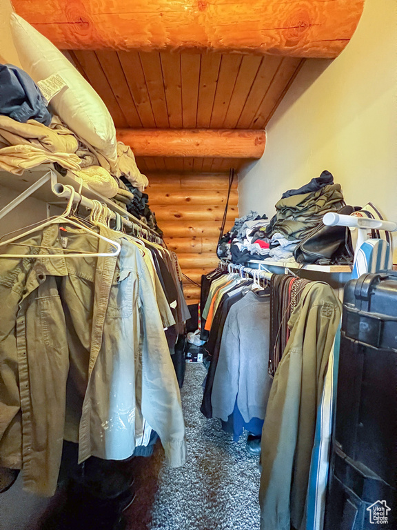 Walk in closet featuring beam ceiling