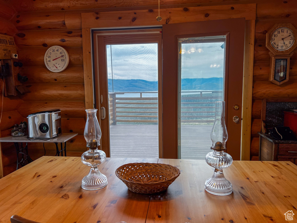 Dining area with a mountain view, plenty of natural light, and rustic walls