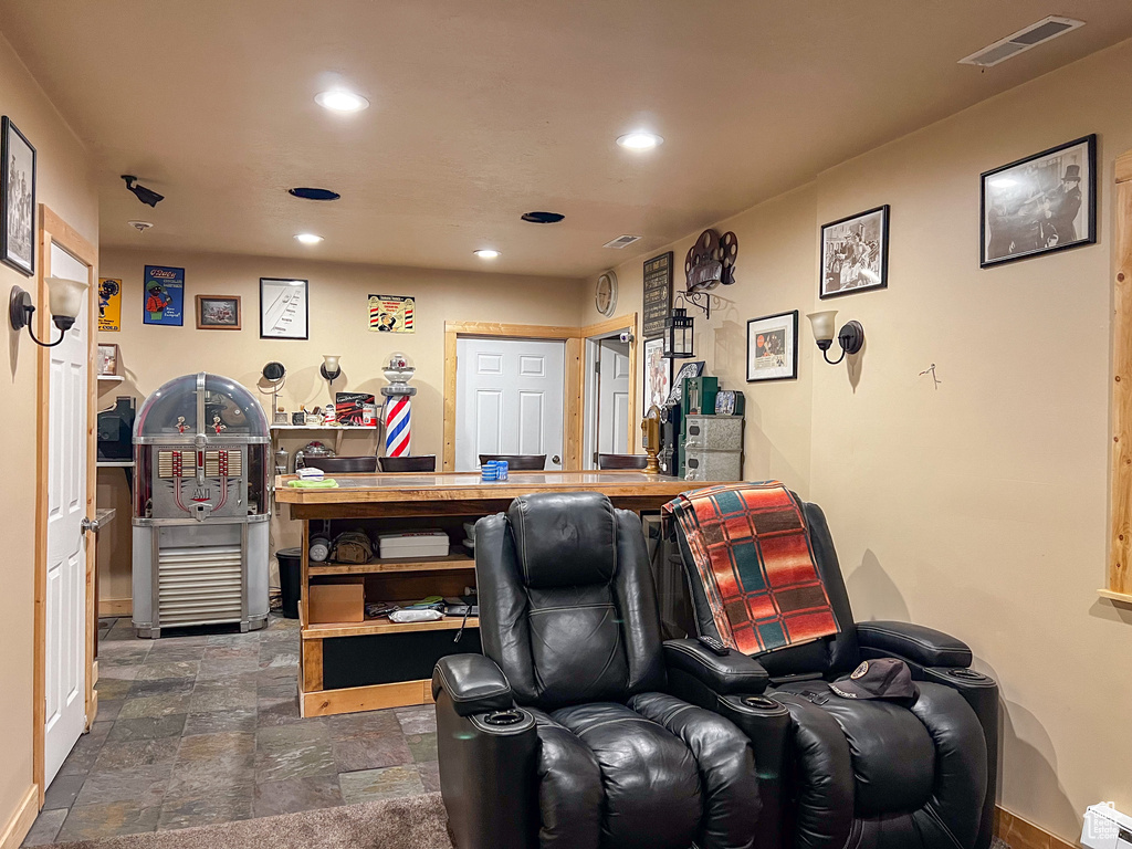 Home theater room with dark tile patterned flooring