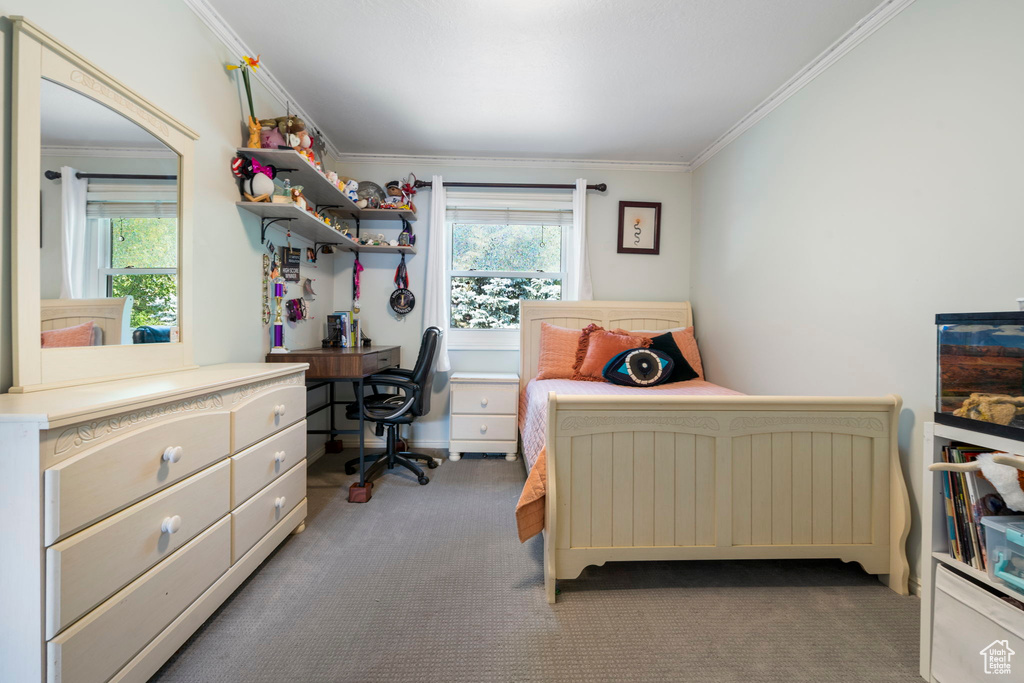 Carpeted bedroom featuring ornamental molding