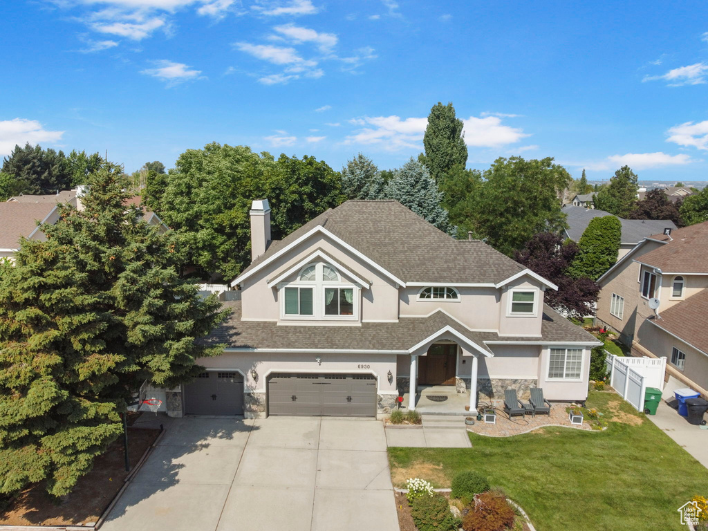 View of front of house featuring a garage and a front lawn