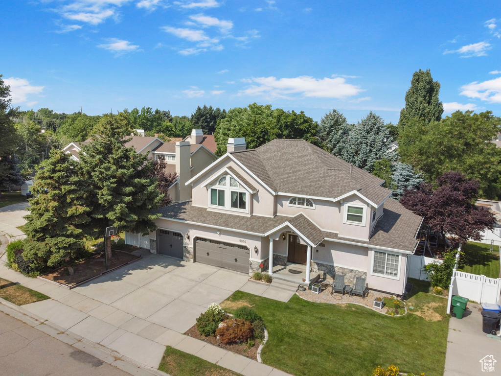 View of front of home featuring a garage and a front lawn