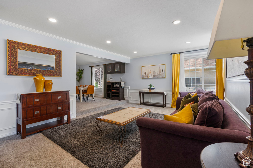 Living room featuring light carpet and ornamental molding