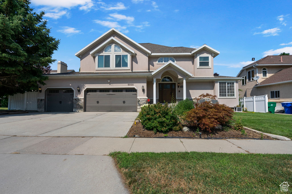 View of front facade with a garage and a front yard