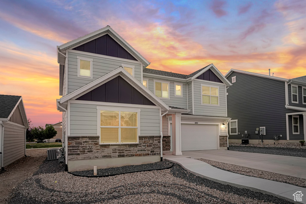 Craftsman house with a garage and central AC