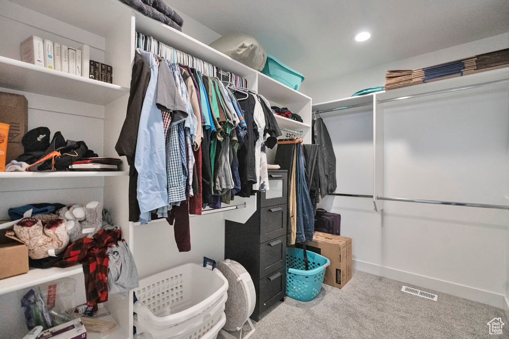 Spacious closet with carpet floors