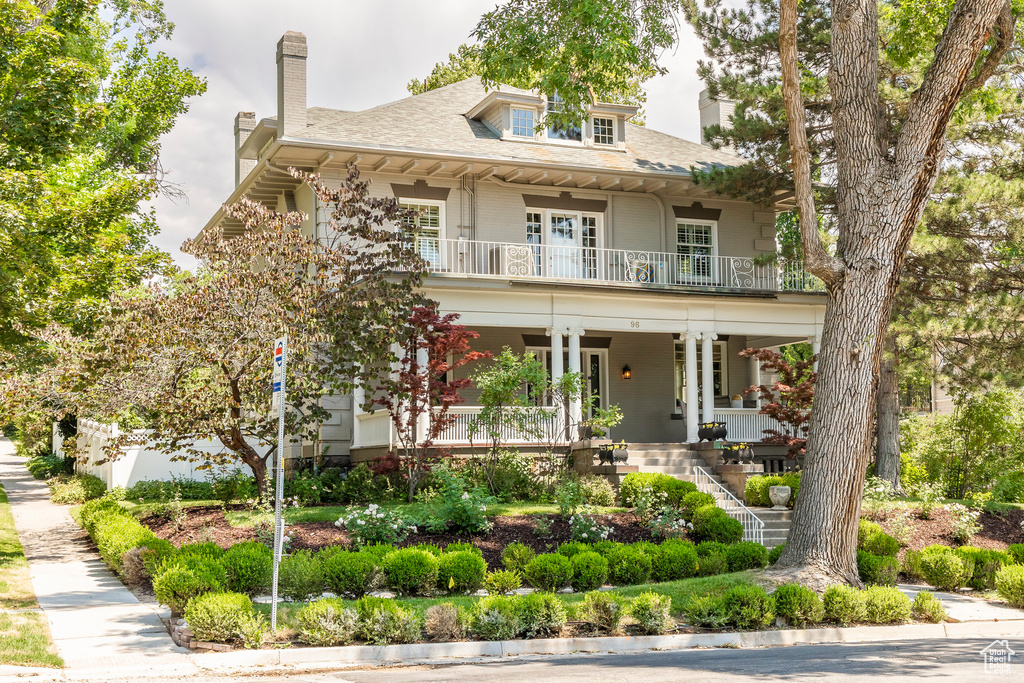 View of front facade with a balcony and covered porch