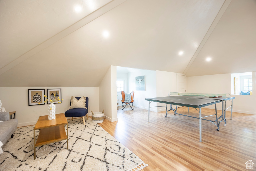 Playroom with light hardwood / wood-style floors and lofted ceiling