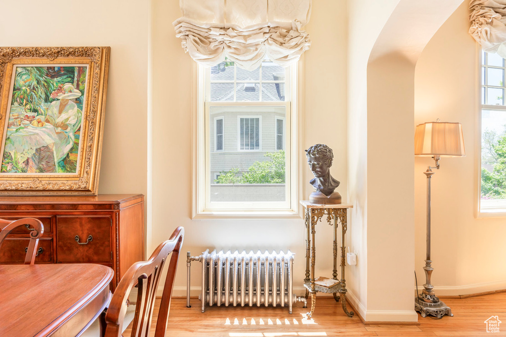 Interior space with radiator heating unit and hardwood / wood-style floors