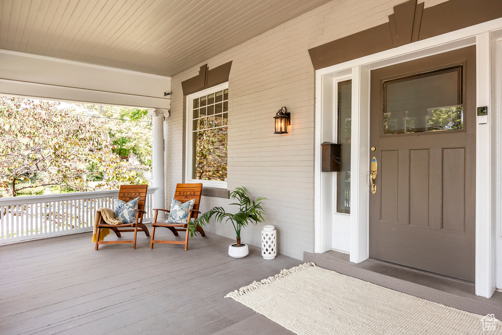 Doorway to property featuring a porch