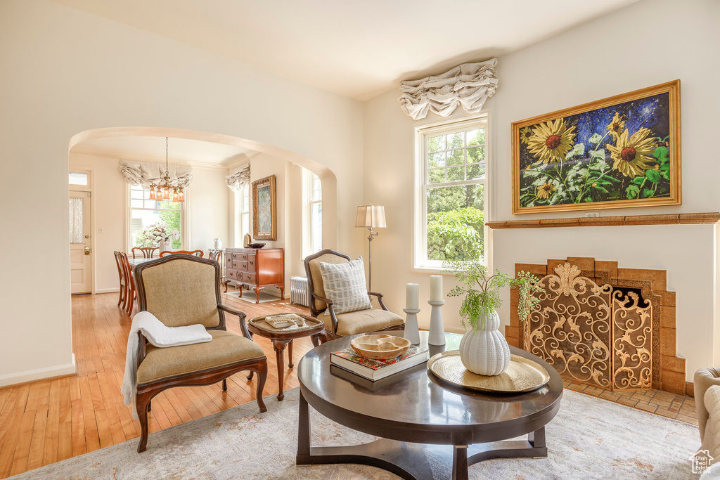 Living area with hardwood / wood-style floors and an inviting chandelier