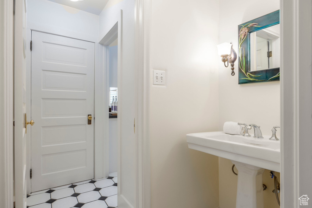 Bathroom with tile patterned flooring and sink