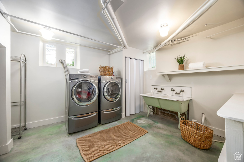 Laundry area featuring sink and independent washer and dryer